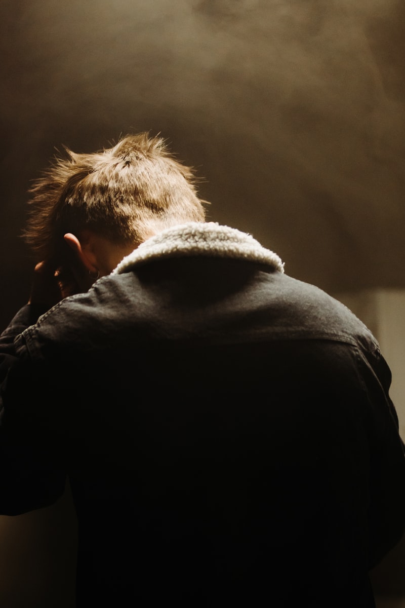 person in black hoodie looking at the sky