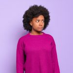 afro black woman against isolated wall